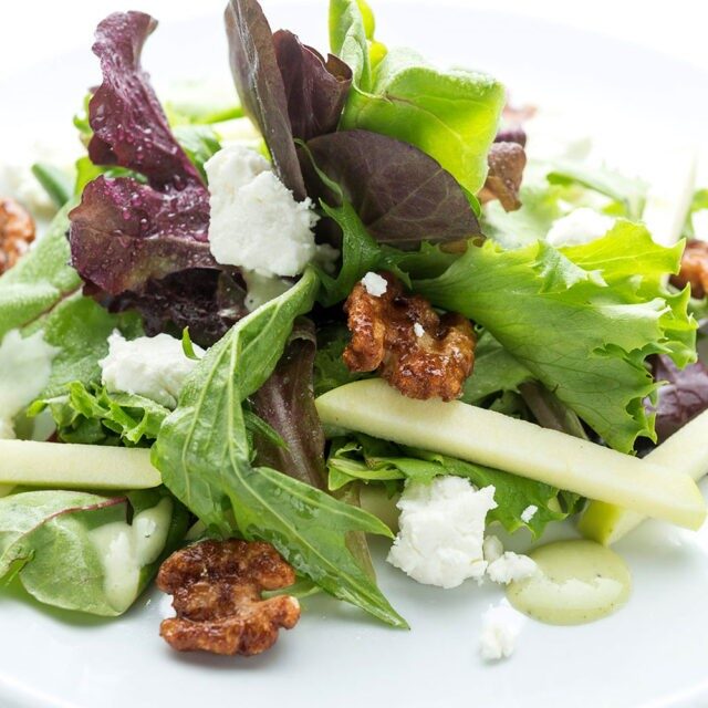 Fresh green salad with walnuts and creamy cheese. Fresh green salad with walnuts and creamy cheese.